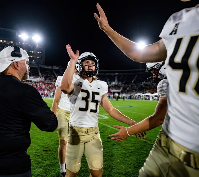 Colton Boomer High-Fiving Teammates on the Sideline